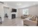Cozy living room with a fireplace, large sectional sofa, and natural lighting at 164 Wilson Farm Ln, Clayton, NC 27527
