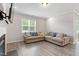 Comfortable living area featuring a large window and spacious sectional sofa at 164 Wilson Farm Ln, Clayton, NC 27527