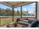 Relaxing screened-in porch with comfortable seating and a beautiful view of the backyard and trees at 164 Wilson Farm Ln, Clayton, NC 27527