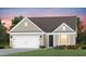 Charming single-Gathering home featuring a two-car garage, beautiful landscaping, and a cozy front porch at 1825 Angelonia Way, Fuquay Varina, NC 27526