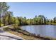Scenic view of lake surrounded by lush green trees at 1825 Angelonia Way, Fuquay Varina, NC 27526