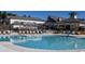 A picturesque view of a resort-style community pool surrounded by lush landscaping and amenities at 1825 Angelonia Way, Fuquay Varina, NC 27526