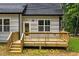 Backyard exterior featuring a wooden deck, steps leading down, and vinyl siding at 188 Buckaroo Dr, Louisburg, NC 27549