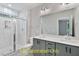 Modern bathroom with dual vanity, gray cabinets, and a glass shower at 188 Buckaroo Dr, Louisburg, NC 27549