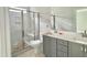 New bathroom featuring gray vanity, large shower with seat, and double sinks at 188 Buckaroo Dr, Louisburg, NC 27549
