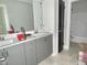 New bathroom with a double sink gray vanity, and a view of a shower and toilet at 188 Buckaroo Dr, Louisburg, NC 27549