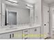 Elegant bathroom features a double sink vanity, a large mirror, and sleek lighting fixtures at 188 Buckaroo Dr, Louisburg, NC 27549