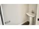 Half bathroom featuring a pedestal sink, chrome fixtures, and modern hardware at 188 Buckaroo Dr, Louisburg, NC 27549
