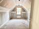 A bedroom underneath the roof with a dormer window at 188 Buckaroo Dr, Louisburg, NC 27549