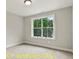 Cozy bedroom filled with natural light from the bright window, featuring neutral carpet and white trim at 188 Buckaroo Dr, Louisburg, NC 27549