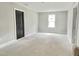 Bedroom with neutral walls and trim and a dark colored door at 188 Buckaroo Dr, Louisburg, NC 27549