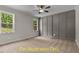 Spacious bedroom features a fan, multiple windows, gray accent wall, and plush carpet at 188 Buckaroo Dr, Louisburg, NC 27549