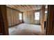 Unfinished bedroom features two large windows letting in plenty of natural light, and unfinished floors and walls at 188 Buckaroo Dr, Louisburg, NC 27549