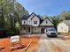 Charming new construction home with craftsman details, set among mature trees, and a well-lit front yard at 188 Buckaroo Dr, Louisburg, NC 27549
