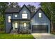 Illustration of the home's exterior elevation with stone accents, covered porch, and a two-car garage at 188 Buckaroo Dr, Louisburg, NC 27549