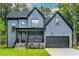 Charming exterior showcasing a modern home with blue siding, covered porch, and attached garage at 188 Buckaroo Dr, Louisburg, NC 27549