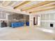 Spacious kitchen and living area featuring wooden beams, gray cabinets, and an open-concept design at 188 Buckaroo Dr, Louisburg, NC 27549