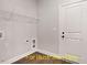 Well-lit laundry room with wood-look floors, wire shelving, and convenient hookups at 188 Buckaroo Dr, Louisburg, NC 27549