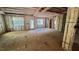 Unfinished living room featuring large windows and a glass door with a view of the trees outside at 188 Buckaroo Dr, Louisburg, NC 27549
