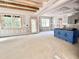 Open living room with abundant natural light, kitchen access, and charming wooden ceiling beams at 188 Buckaroo Dr, Louisburg, NC 27549