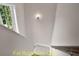 Bright white staircase with a window view, showcasing the clean design of the home's interior at 188 Buckaroo Dr, Louisburg, NC 27549