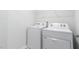 Efficient laundry room with white washer and dryer at 1901 Hinesley Dr, Durham, NC 27703
