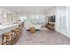 Open-concept living area with modern furniture, large windows, and hardwood floors at 1901 Hinesley Dr, Durham, NC 27703