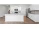 Open kitchen featuring a spacious island with bar seating and stainless steel appliances at 1903 Hinesley Dr, Durham, NC 27703