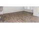 Living room area with wood-look floors, sliding glass doors, and natural light at 1903 Hinesley Dr, Durham, NC 27703