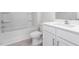 A full white bathroom features modern hardware, a shower and tub combination, and hard surface countertops at 1903 Hinesley Dr, Durham, NC 27703