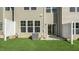 Backyard with green grass, privacy fence, and new home construction at 1905 Hinesley Dr, Durham, NC 27703