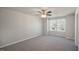 A large bedroom with neutral paint and carpet with a ceiling fan at 1905 Hinesley Dr, Durham, NC 27703