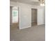 Neutral bedroom with carpet, ceiling fan, and doors leading to other rooms at 1905 Hinesley Dr, Durham, NC 27703