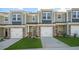 New construction townhouse with brick facade and siding, an attached garage, and a well-manicured front lawn at 1905 Hinesley Dr, Durham, NC 27703