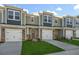 Row of newly-constructed townhouses featuring brick facades, one-car garages, and well-kept lawns at 1905 Hinesley Dr, Durham, NC 27703