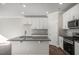 Modern kitchen with island, stainless steel appliances, and white cabinetry at 1905 Hinesley Dr, Durham, NC 27703