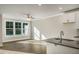 Bright living room with hardwood floors, ceiling fan, and large windows that let in natural light at 1905 Hinesley Dr, Durham, NC 27703