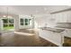 Open floor plan showcasing the kitchen and dining area with hardwood flooring and modern finishes at 1905 Hinesley Dr, Durham, NC 27703