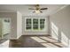 Living room with hardwood floors, a ceiling fan, and sliding glass doors to the backyard at 1905 Hinesley Dr, Durham, NC 27703
