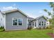 Home's backyard showcasing a well-maintained lawn and a gray siding exterior, a perfect space for outdoor activities at 2021 Clydner Dr, Apex, NC 27523
