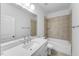 Bright bathroom featuring a bathtub with tile surround, modern fixtures and vanity with plenty of counter space at 2021 Clydner Dr, Apex, NC 27523
