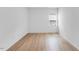 Bright bedroom with neutral paint, wood-look floors, and a window offering natural light at 2021 Clydner Dr, Apex, NC 27523