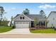 Charming one-story home with well-maintained lawn, two car garage and manicured landscaping at 2021 Clydner Dr, Apex, NC 27523