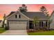 Charming one-story home with well-maintained lawn, two car garage and manicured landscaping at 2021 Clydner Dr, Apex, NC 27523