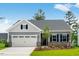 Charming single-story home with a two-car garage, a manicured lawn, and brick accents at 2021 Clydner Dr, Apex, NC 27523