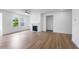 Bright living room with hardwood floors, a fireplace, and large windows for natural light at 2021 Clydner Dr, Apex, NC 27523