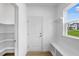 Welcoming mudroom with coat hooks, storage shelves, and a bench at 2021 Clydner Dr, Apex, NC 27523