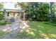 Fenced backyard with a dining table, patio, green grass, shed, and mature trees at 206 N State St, Raleigh, NC 27601