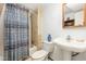 A full bathroom featuring a shower and tub, single vanity, and a decorative shower curtain at 206 N State St, Raleigh, NC 27601