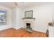 Bedroom featuring hardwood floors, a fireplace, and a bright window with natural light at 206 N State St, Raleigh, NC 27601